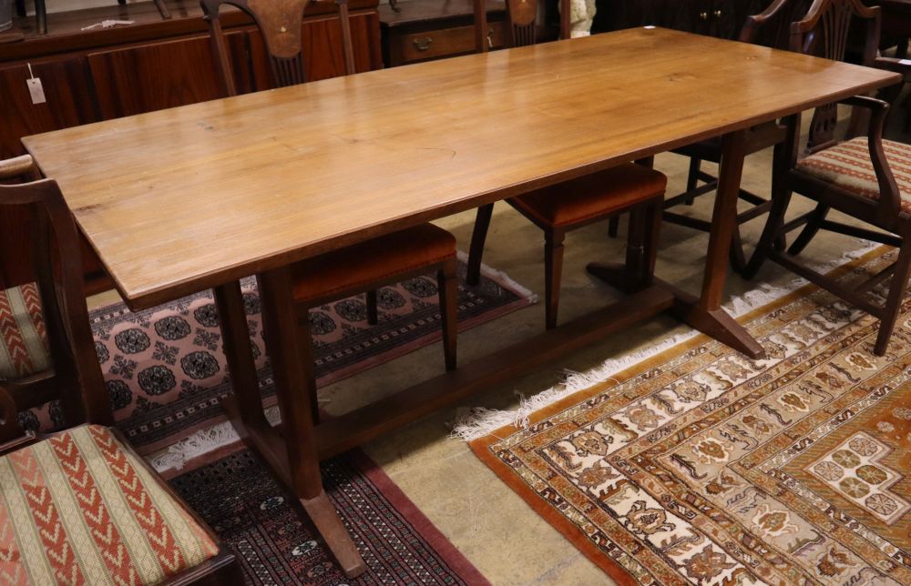 A Gordon Russell walnut dining table, circa 1930, on chamfered double end supports and central stretcher, width 184cm, depth 83cm, heig